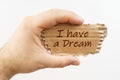 A man holds a cardboard in his hand on which it is written - I have a Dream Royalty Free Stock Photo