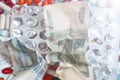 Business finance. Russian money and pills on blue backgrouind. Illness, disease, symptom