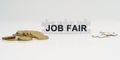 On a white background, there are coins and puzzles with the inscription - JOB FAIR