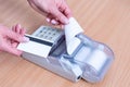 A hand holding a bank card above the cash register to pay for a purchase and issuing a check for payment Royalty Free Stock Photo