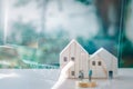 Business and financial concept. Double exposure hand holding credit card and wooden home with small people model stand on a stack Royalty Free Stock Photo