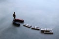 Selective focus image of miniature businessman attracts money using magnet Royalty Free Stock Photo