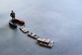 Selective focus image of miniature businessman attracts money using magnet