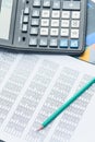 Business financial documents, office calculator and pen on the table. Numbers and graphs