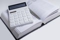 Business financial or tax law concept. Calculator and open book on table Royalty Free Stock Photo