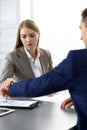 Business finishing up a meeting in office. Business woman looking at partner watches for time controlling