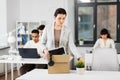 Sad female office worker packing personal stuff Royalty Free Stock Photo