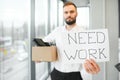 Business, Firing and Job Loss Concept - Sad Fired Male Office Worker With Box of His Personal Stuff