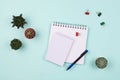 Business flatlay with various notebook with blank pages, pen, succulents and cactuses and clips on a table