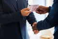 Business fraud, corruption handshake and money deal, scam and criminal giving euro notes, bribery payment and illegal Royalty Free Stock Photo