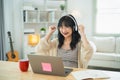 Business freelance entrepreneur woman wearing eyeglass and white headphone hand up cheerful successful, working typing keyboard on Royalty Free Stock Photo