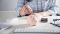 Business girl putting coin to piggy bank. Saving money Royalty Free Stock Photo
