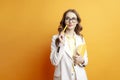 business girl in suit holds documents and thinking, female student in blazer dreams and looking to copy space Royalty Free Stock Photo