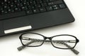 Business glasses near a laptop keyboard Royalty Free Stock Photo