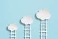Business goal, strategy concept, white clouds paper cut with ladders on grunge green texture background Royalty Free Stock Photo