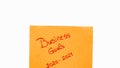 Business goals 2020-2021 handwriting text close up isolated on orange paper with copy space. Writing text on memo post reminder