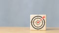 Business goals and success. Darts aim icon on wooden cube copy space Royalty Free Stock Photo