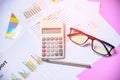 Business graph chart report paper financial document with calculator pen and glasses Royalty Free Stock Photo