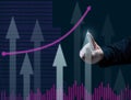 Business graph of the dynamics of indicators and a man`s hand points a finger to the highest column, dark blue background.