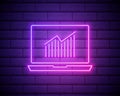 Business graph neon sign. Pc monitor with graphic neon banner on brick wall background