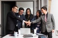 business group team putting hands together smiling celebrating success, meeting room office ambience, hispanic people, diverse Royalty Free Stock Photo