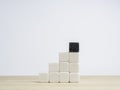 Business growth, benefit building process concept. The last one difference black dice cube block on top of white dice cube blocks. Royalty Free Stock Photo