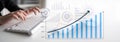 Business growth concept with hands on keyboard, financial graphs, charts, and data analysis on modern workspace Royalty Free Stock Photo