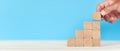 business growth concept. man stacks wooden blocks in increasing order. Royalty Free Stock Photo