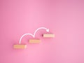 Business growth or increasing concept picture, the rising arrow on wooden blocks the staircase isolated on a pink background Royalty Free Stock Photo