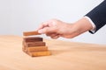 business hand arranging wood block stacking as step stair. Ladder career path concept for business growth success process