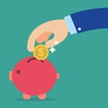 Business hand holding coin into red piggy bank Royalty Free Stock Photo