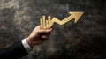 Golden Growth Chart Arrow Held by Businessman Hand Royalty Free Stock Photo