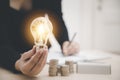 Business hand holding light bulb and working on the desk, Creativity and innovation are keys to success.Concept of new idea and in Royalty Free Stock Photo