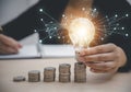 Business hand-holding light bulbs and working on the desk, Creativity, and innovation are keys to success. Concept of new idea and Royalty Free Stock Photo