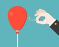 Business Hand with pin try to burst or popping red balloon, flat