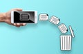 Business hand throw data file from mobile to trash