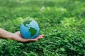 Business hands holding Earth with nature background.World environment day. Global community teamwork.Volunteer charity work Royalty Free Stock Photo