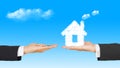 Business Hands with money and house from clouds Royalty Free Stock Photo