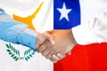 Handshake on Cyprus and Chile flag background