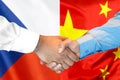 Handshake on Czech Republic and China flag background