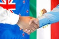 Handshake on New Zealand and Mexico flag background