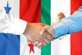 Handshake on Panama and Mexico flag background