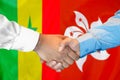 Handshake on Senegal and Hong Kong flag background. Support concept Royalty Free Stock Photo