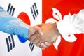 Handshake on South Korea and Hong Kong flag background Royalty Free Stock Photo