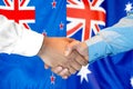 Handshake on New Zealand and Australia flag background