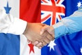 Handshake on Panama and Australia flag background