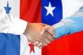 Handshake on Panama and Chile flag background