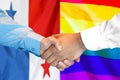 Handshake on Panama and LGBT gay flag background