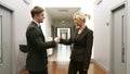 Business handshake in a corridor