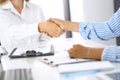 Business handshake at meeting or negotiation in office. Partners shaking hands while satisfied because signing contract